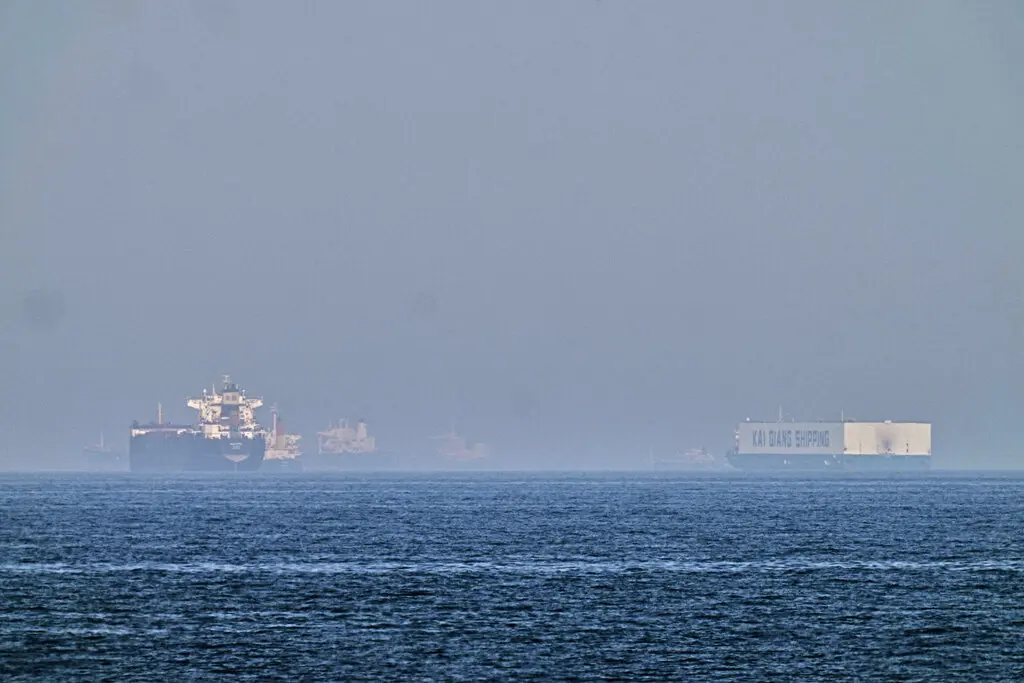 A Maersk 'military' ship passes by Hormuz, which is under crossfire.